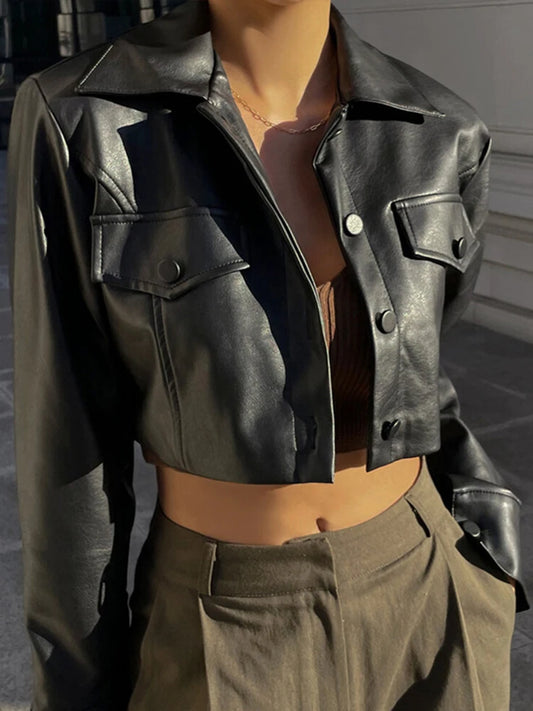 Mannequin wearing a black leather jacket and brown pants in a neutral setting