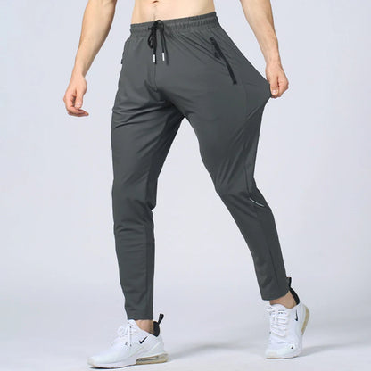 Gray athletic pants worn by a person on a light gray background
