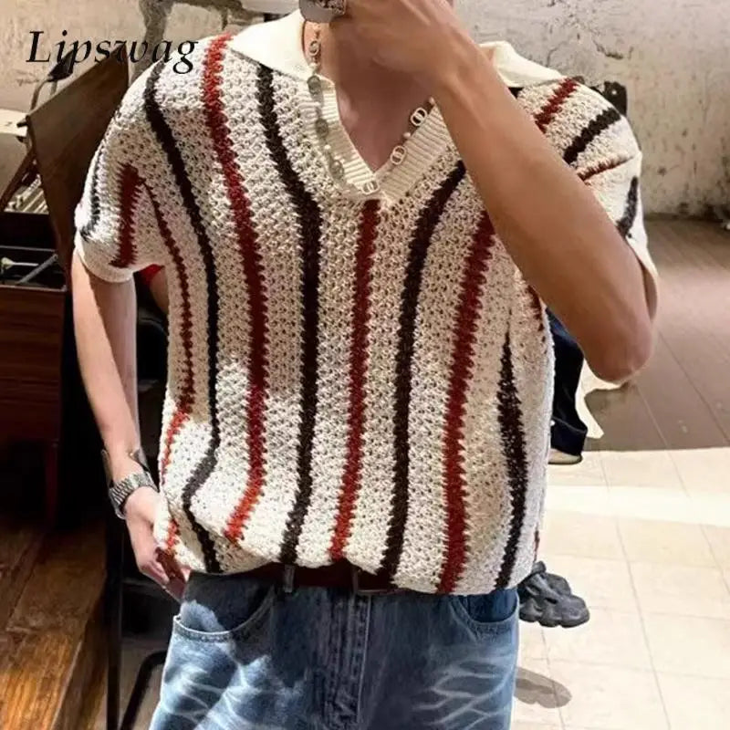 Person wearing a striped crochet sweater in an indoor setting