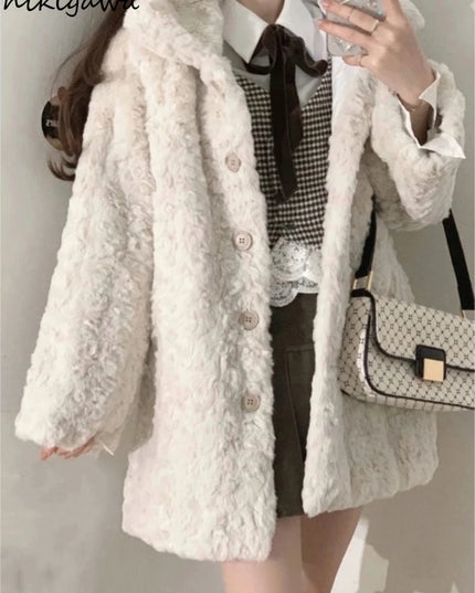Person wearing a white fluffy coat with a checkered shirt and holding a patterned handbag.