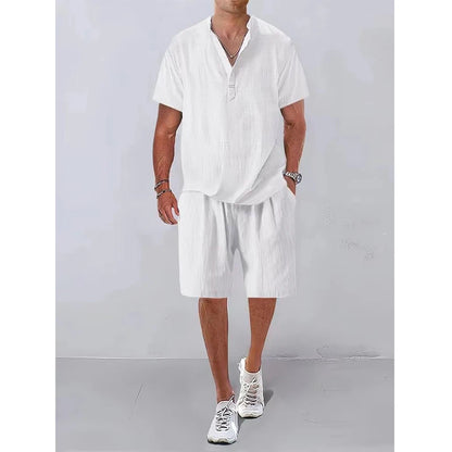 Person wearing a white outfit with shorts against a plain background