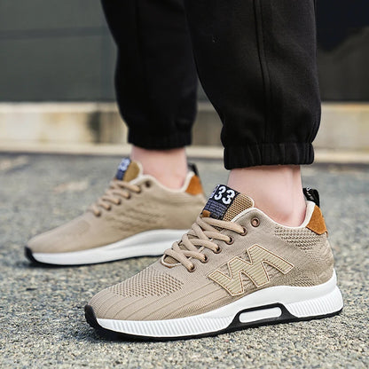 Beige sneakers with white soles worn on a concrete surface