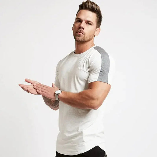 Man wearing a white and gray t-shirt on a plain background
