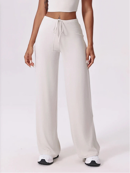 White wide-leg pants worn by a person on a white background