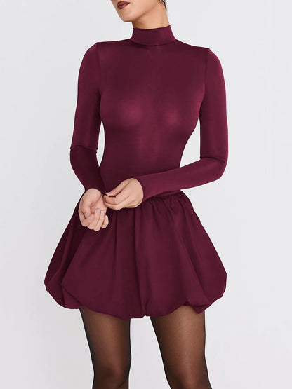 Maroon dress worn by a model on a white background