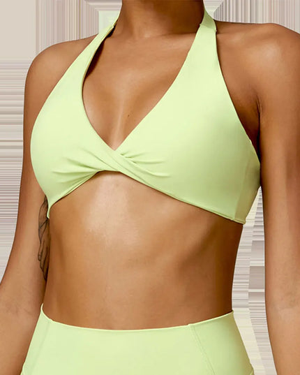 Person wearing a light green bikini set against a neutral background