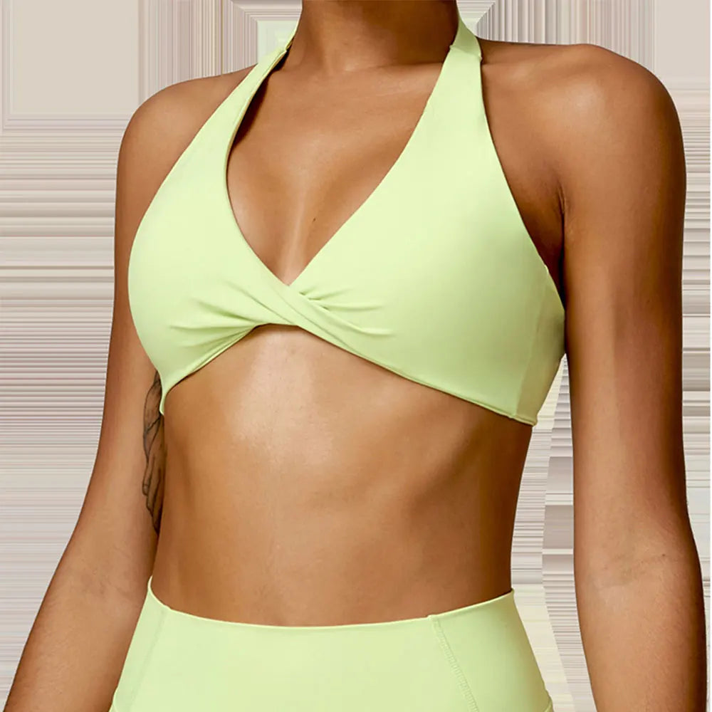 Person wearing a light green bikini set against a neutral background