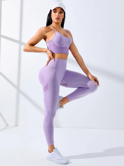 Woman wearing a purple athletic outfit posing against a white background
