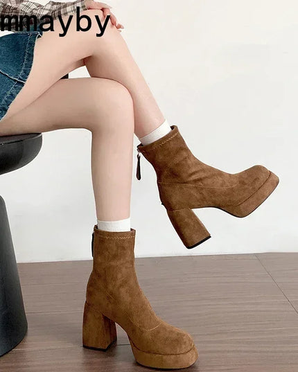 Brown platform boots worn by a person sitting on a chair with a white background.