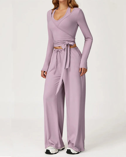 Purple jumpsuit with a tie waist on a white background