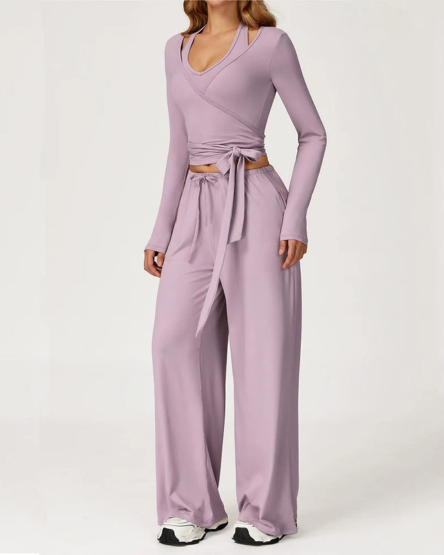 Purple jumpsuit with a tie waist on a white background