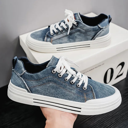 Blue denim sneakers with white soles on a dark surface