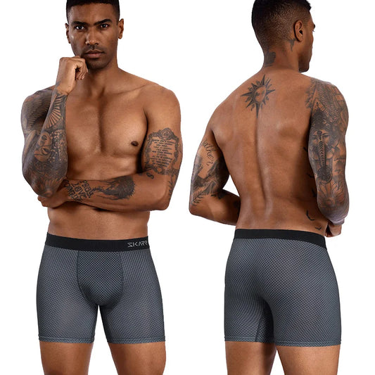 Man wearing gray boxer briefs with a brand logo, shown from front and back.