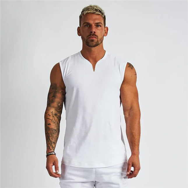 Man wearing a white sleeveless shirt against a plain background