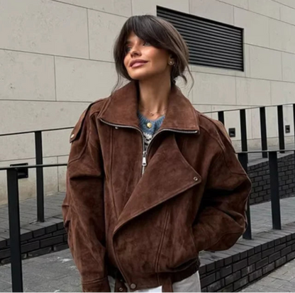 Woman wearing a brown jacket standing in front of a building