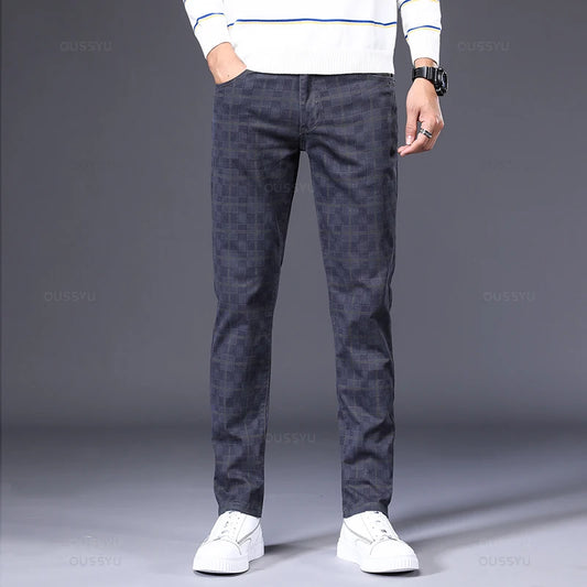 Person wearing dark patterned pants and a white sweater on a gray background