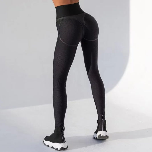 Black leggings worn by a person on a light gray background