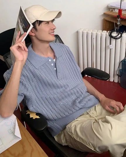 Person sitting in a room with a desk and radiator visible