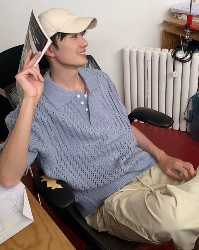 Person sitting in a room with a desk and radiator visible