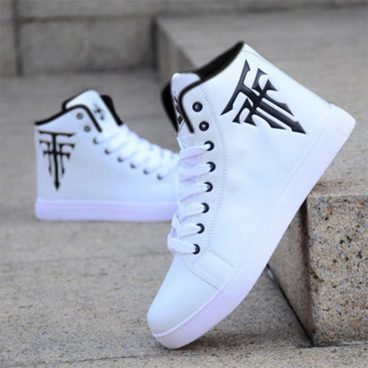 White high-top sneakers with black logo on a stone surface
