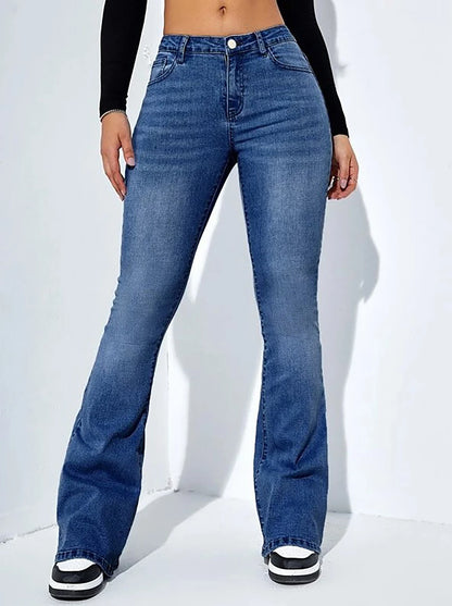 Person wearing blue flared jeans on a white background