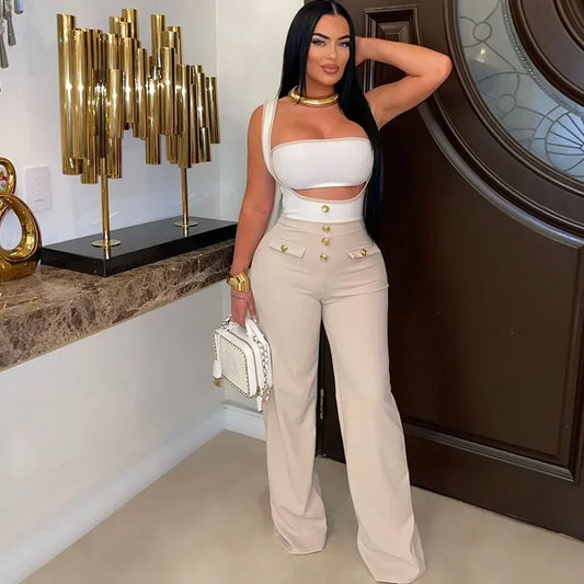 Woman in a stylish outfit posing indoors with decorative elements in the background