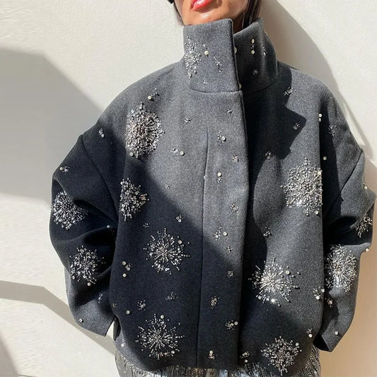 Gray coat with decorative elements on a neutral background