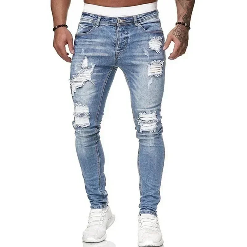 Ripped blue jeans worn by a person on a white background