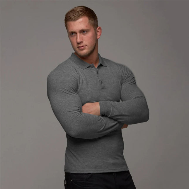 Man wearing a gray long-sleeve polo shirt against a gray background