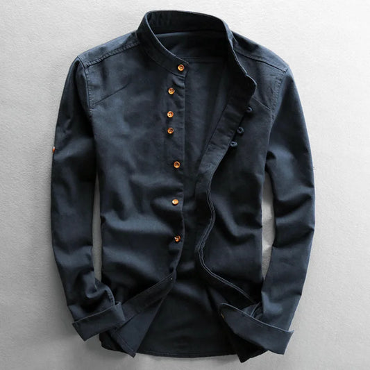 Dark blue shirt with orange buttons on a light gray background