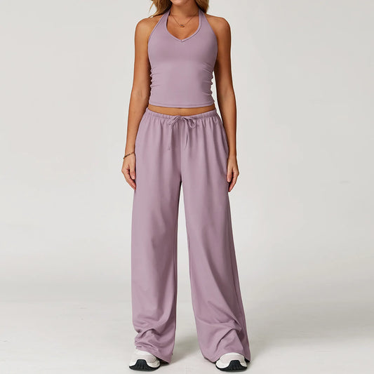 Person wearing a matching lavender tank top and pants set on a plain background