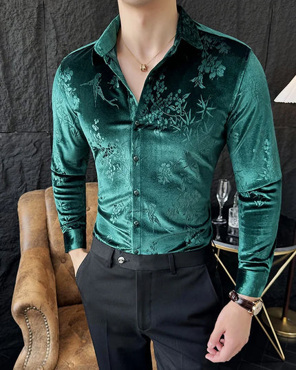 Man wearing a green floral patterned shirt in an indoor setting.