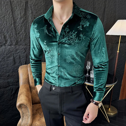 Man wearing a green floral patterned shirt in an indoor setting.