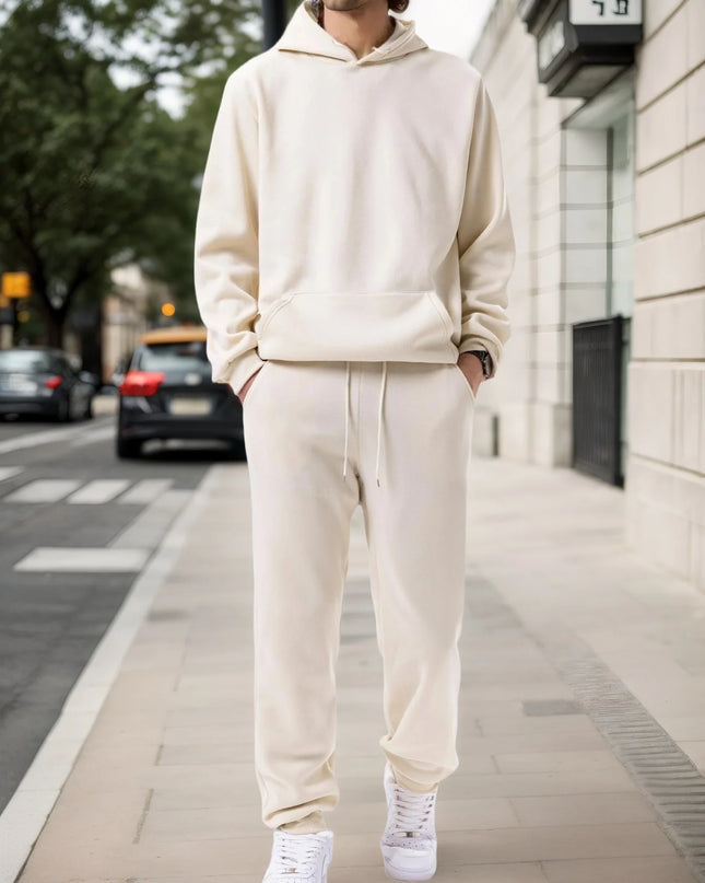 Person wearing a beige tracksuit on a city street