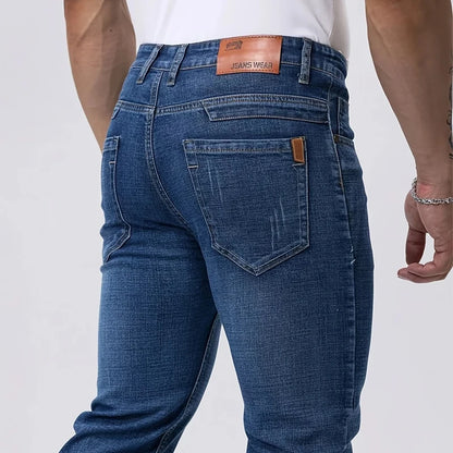 Blue jeans with a visible brand label on a white background
