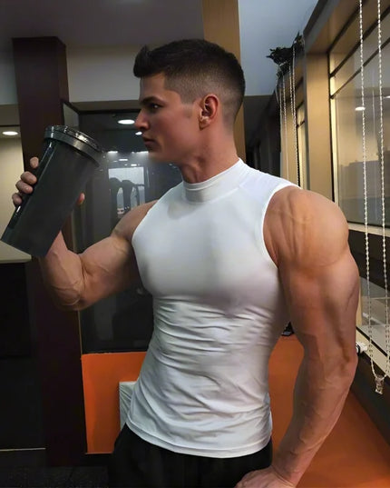 Muscular man in a white tank top holding a protein shaker in a gym setting