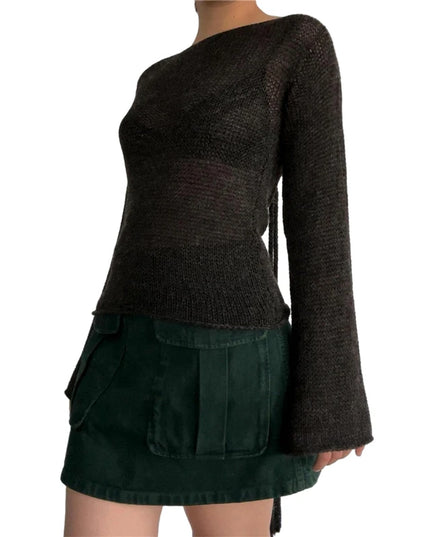 Dark brown sweater over a green skirt on a white background