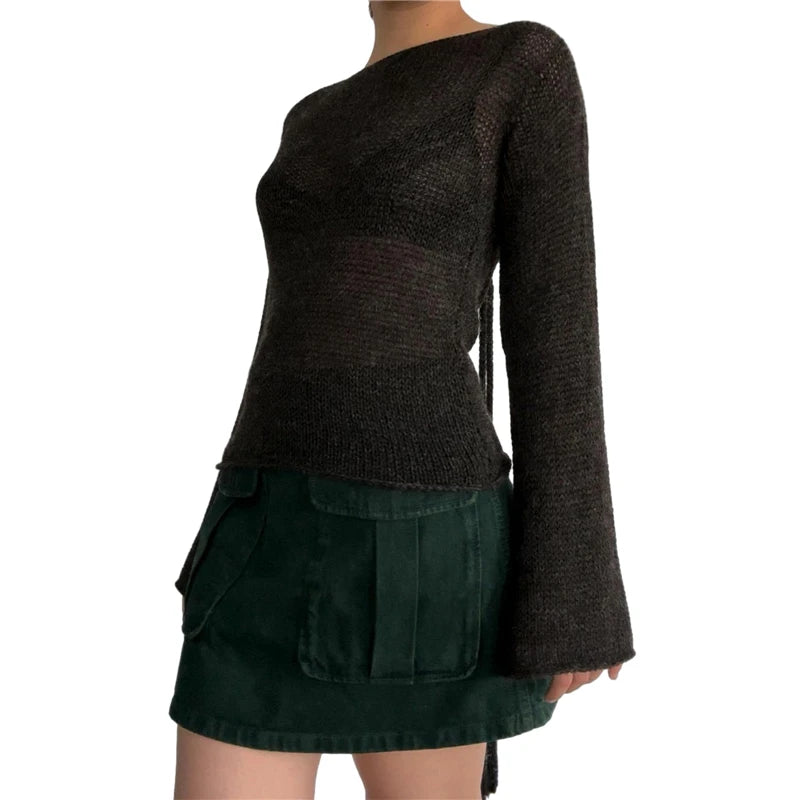 Dark brown sweater over a green skirt on a white background