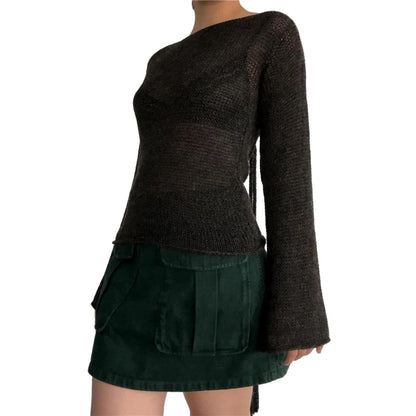 Dark brown sweater over a green skirt on a white background